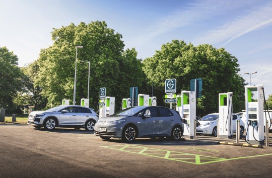 Image shows electric vehicles charging at a moto service station